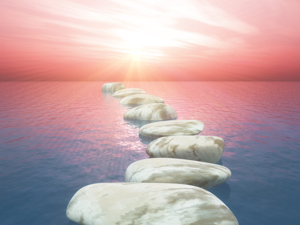 3D render of stepping stones in ocean against sunset sky